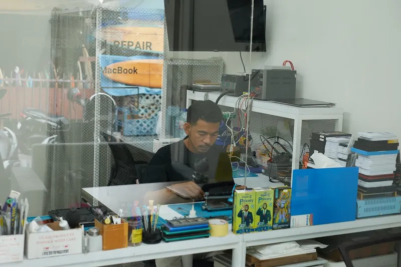 FixBox technician at the repair bench in the Canggu workshop