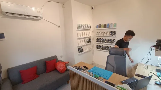 Inside FixBox Ubud — service desk, accessory display and seating area